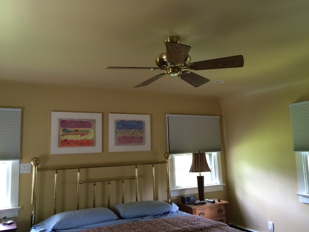 Painting walls and ceiling in the same color gives a "held" cozy feeling to a bedroom.